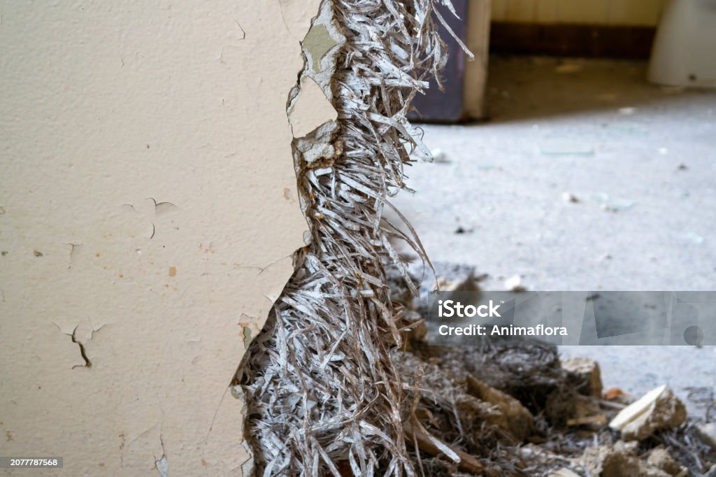 Old asbestos in a wall in the room, harmful to health Old asbestos in a wall in the room, harmful to health